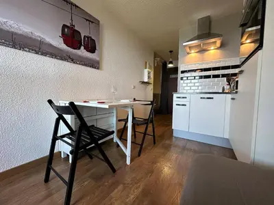 a kitchen with a table and chairs in a room at Studio cosy aux pieds des pistes, vue splendide - FR-1-624-53 in Samoëns
