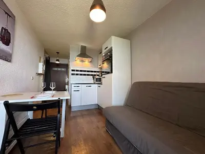 a small kitchen with a couch and a table in a room at Studio cosy aux pieds des pistes, vue splendide - FR-1-624-53 in Samoëns