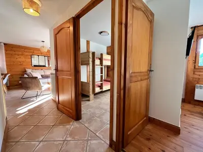 a door leading to a room with a bedroom at Appartement T3 au cœur de Samoëns avec balcon et parking privatif - FR-1-624-54 in Samoëns