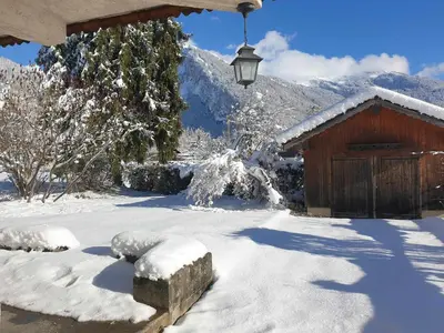 a snow covered yard with a barn and a light at Appartement chalet calme, proche centre, animaux acceptés - FR-1-624-45 in Samoëns