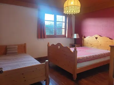 a bedroom with two beds and a chandelier at Appartement chalet calme, proche centre, animaux acceptés - FR-1-624-45 in Samoëns