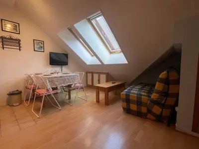 a living room with a table and a window at Studio duplex lumineux au centre de Samoëns avec parking - FR-1-624-58 in Samoëns