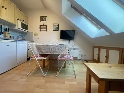 a kitchen with a table and chairs in a room at Studio duplex lumineux au centre de Samoëns avec parking - FR-1-624-58 in Samoëns