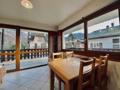 a dining room with a table and some windows at Appartement T2 avec balcon au centre de Samoëns - FR-1-624-44 in Samoëns