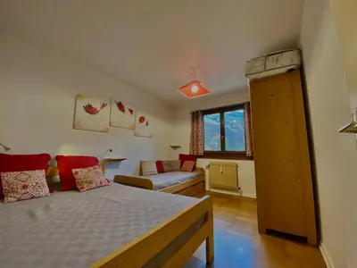 a small bedroom with a bed and a couch at Appartement T2 avec balcon au centre de Samoëns - FR-1-624-44 in Samoëns