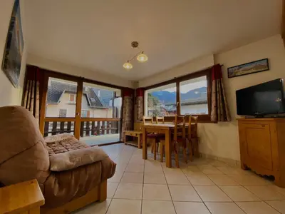 a living room with a couch and a table with a television at Appartement T2 avec balcon au centre de Samoëns - FR-1-624-44 in Samoëns