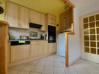 a kitchen with wooden cabinets and a white refrigerator at Appartement T2 avec balcon au centre de Samoëns - FR-1-624-44 in Samoëns
