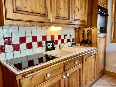 a kitchen with a sink and a tiled counter top at Superbe appartement au centre de Samoëns avec terrasse - FR-1-624-46 in Samoëns