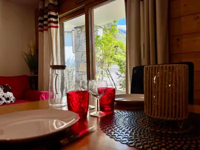a table with two glasses on a table with a window at Superbe appartement au centre de Samoëns avec terrasse - FR-1-624-46 in Samoëns