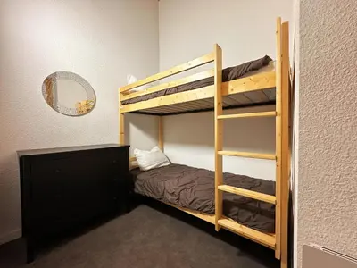 a bedroom with a bunk bed and a mirror at Charmant T2 en centre-ville avec balcon et animaux acceptés - FR-1-624-43 in Samoëns