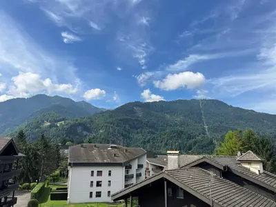 a view of a mountain from a town with houses at Charmant T2 en centre-ville avec balcon et animaux acceptés - FR-1-624-43 in Samoëns