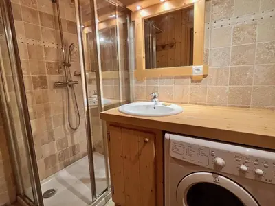 a bathroom with a sink and a washing machine at Appartement T3 confortable proche centre avec balcon et parking - FR-1-624-42 in Samoëns