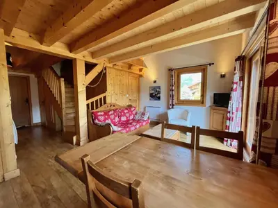 a living room with a table and a couch at Appartement T3 confortable proche centre avec balcon et parking - FR-1-624-42 in Samoëns