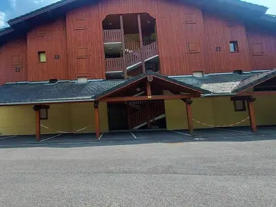 a large building with a balcony on the side of it at Appartement T2 avec Balcon et Parking à Samoëns - FR-1-624-37 in Samoëns