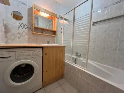 a bathroom with a washing machine and a bath tub at Appartement T2 avec Balcon et Parking à Samoëns - FR-1-624-37 in Samoëns