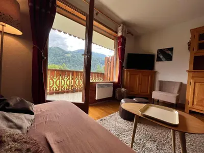 a living room with a view of a balcony at Appartement T2 avec Balcon et Parking à Samoëns - FR-1-624-37 in Samoëns