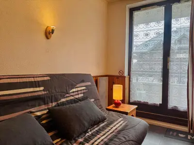 a living room with a table and a bedroom at Studio cosy au cœur du village avec animaux admis et parking - FR-1-624-57 in Samoëns