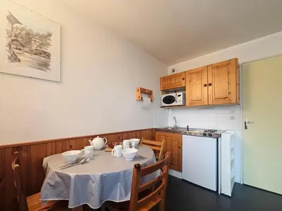 a kitchen and dining room with a table and chairs at Studio cosy au cœur du village avec animaux admis et parking - FR-1-624-57 in Samoëns