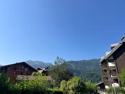 a view of a town with mountains in the background at Appartement T2 avec jardinet proche du centre, Wi-Fi, garage - FR-1-624-61 in Samoëns