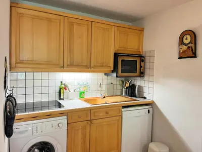 a kitchen with a sink and a washing machine at Appartement T2 avec jardinet proche du centre, Wi-Fi, garage - FR-1-624-61 in Samoëns