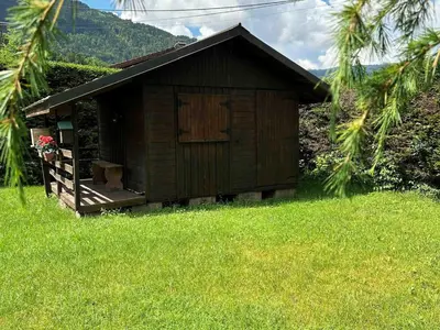a small shack in a field of green grass at Chalet familial avec jardin et cheminée, animaux acceptés - FR-1-624-67 in Samoëns