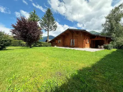 a small wooden house with a large grassy yard at Chalet familial avec jardin et cheminée, animaux acceptés - FR-1-624-67 in Samoëns