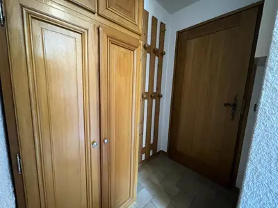 a hallway with wooden cabinets and a door at Résidence Les Granges De Colomb - Granges de Colomb B106 MAE-5322 in Combloux
