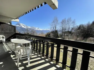 a table and chairs on a balcony with a view of mountains at Résidence Les Granges De Colomb - Granges de Colomb B106 MAE-5322 in Combloux