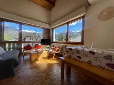 a living room with a view of a mountain at Duplex familial cœur de village, animaux admis - FR-1-624-1 in Samoëns