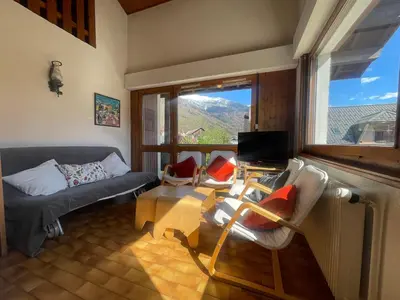 a living room with a couch and chairs and a window at Duplex familial cœur de village, animaux admis - FR-1-624-1 in Samoëns