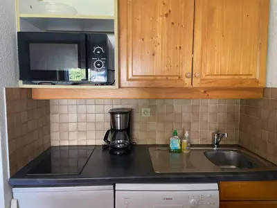 a kitchen counter with a coffee maker and a microwave at Studio lumineux au centre de Samoëns, vue sur Le Criou - FR-1-624-52 in Samoëns