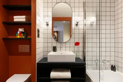 a bathroom with a sink and a tub and a mirror at RockyPop Flaine Hotel & Spa in Flaine