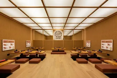 a dining room with tables and chairs and a clock at RockyPop Flaine Hotel & Spa in Flaine