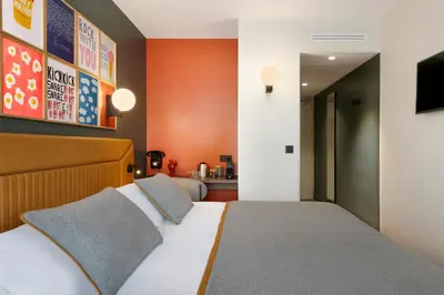 a hotel room with a bed and a television at RockyPop Flaine Hotel & Spa in Flaine