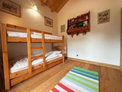 a bedroom with two bunk beds and a rug at Superbe duplex, proche télécabine, animaux acceptés - FR-1-624-13 in Samoëns