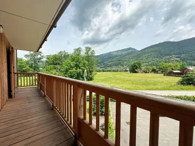 a deck with a view of a field and mountains at Superbe duplex, proche télécabine, animaux acceptés - FR-1-624-13 in Samoëns