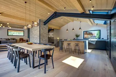 an open kitchen and dining room with a table and chairs at Chalet Breitalps in Chamonix-Mont-Blanc