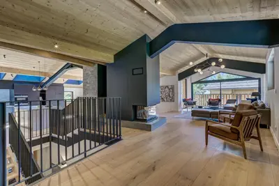 a living room with blue walls and a staircase at Chalet Breitalps in Chamonix-Mont-Blanc