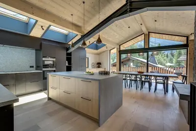 an open kitchen and dining room with a dining table at Chalet Breitalps in Chamonix-Mont-Blanc