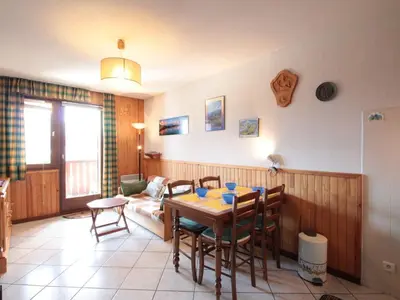 a living room with a table and chairs and a couch at 2P au centre avec parking proche des pistes pour 4 pers - FR-1-572-65 in Les Carroz d'Araches