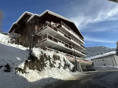 a building on top of a snow covered hill at 2P au centre avec parking proche des pistes pour 4 pers - FR-1-572-65 in Les Carroz d'Araches