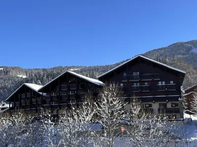 a large building with snow on the ground at 2P au centre avec parking proche des pistes pour 4 pers - FR-1-572-65 in Les Carroz d'Araches
