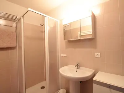 a white bathroom with a sink and a shower at 2P au centre avec parking proche des pistes pour 4 pers - FR-1-572-65 in Les Carroz d'Araches