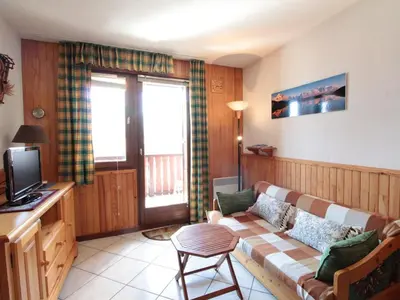 a living room with a couch and a tv at 2P au centre avec parking proche des pistes pour 4 pers - FR-1-572-65 in Les Carroz d'Araches