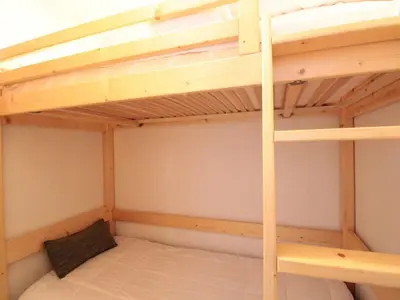a bedroom with two bunk beds in a room at 2P au centre avec parking proche des pistes pour 4 pers - FR-1-572-65 in Les Carroz d'Araches