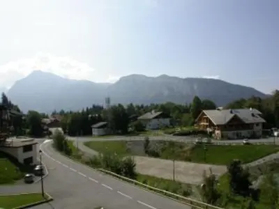 a view of a road with mountains in the background at 2P au centre avec parking proche des pistes pour 4 pers - FR-1-572-65 in Les Carroz d'Araches