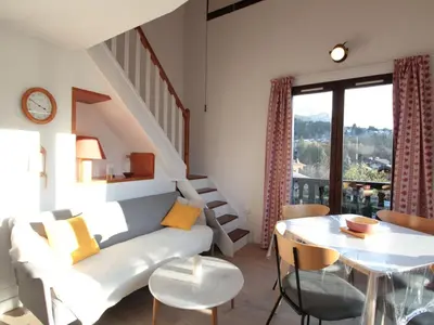 a living room with a couch and a table at Duplex 2P/4 avec Balcon, WIFI et Parking Les Carroz - FR-1-572-15 in Les Carroz d'Araches