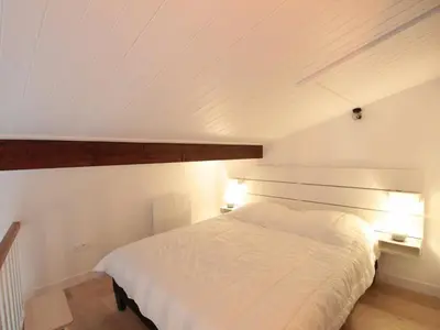 a bedroom with a white bed and two lights at Duplex 2P/4 avec Balcon, WIFI et Parking Les Carroz - FR-1-572-15 in Les Carroz d'Araches