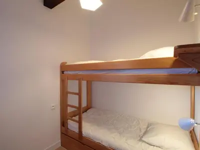 a bedroom with two bunk beds in a room at Duplex 2P/4 avec Balcon, WIFI et Parking Les Carroz - FR-1-572-15 in Les Carroz d'Araches