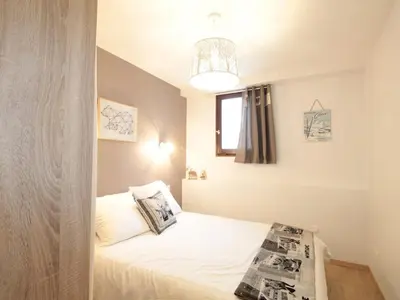 a small bedroom with a bed with a window at Charme au centre d'Arâches : 2 pièces + coin montagne, 4/5 pers, proche pistes et commerces - FR-1-572-154 in Les Carroz d'Araches